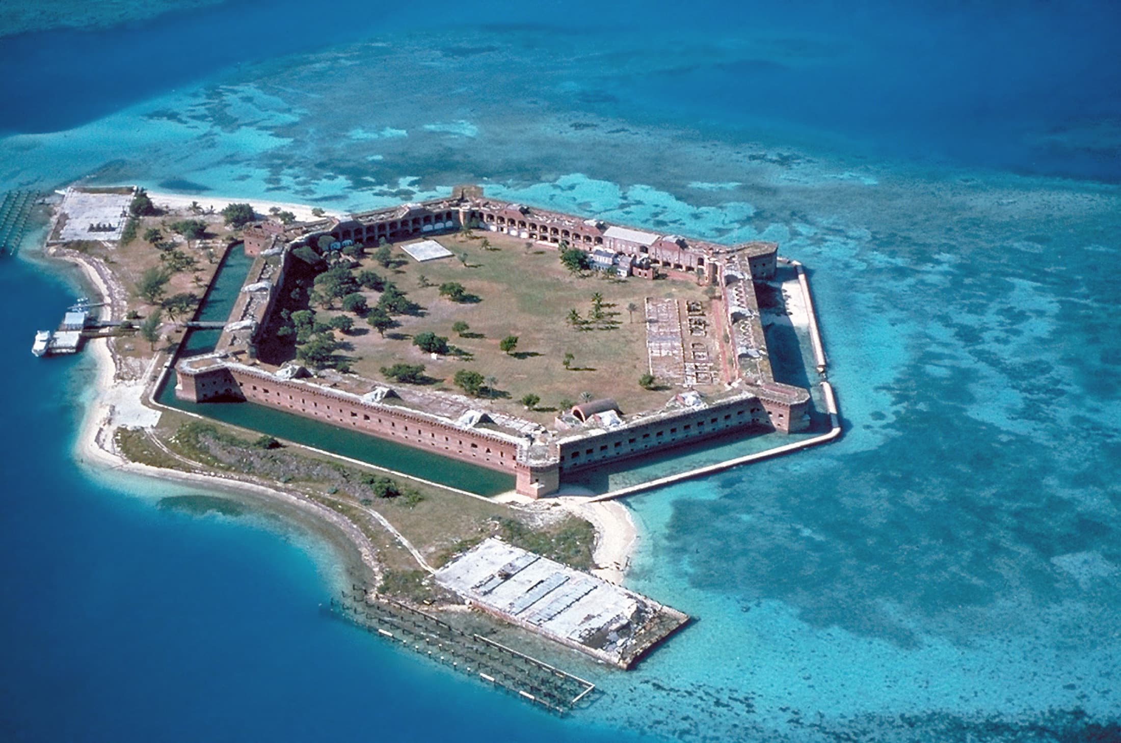 Aerial view of the hexagonal masonry Fort Jefferson on Garden Key in Dry Tortugas National Park, surrounded by shallow turquoise Gulf of Mexico waters