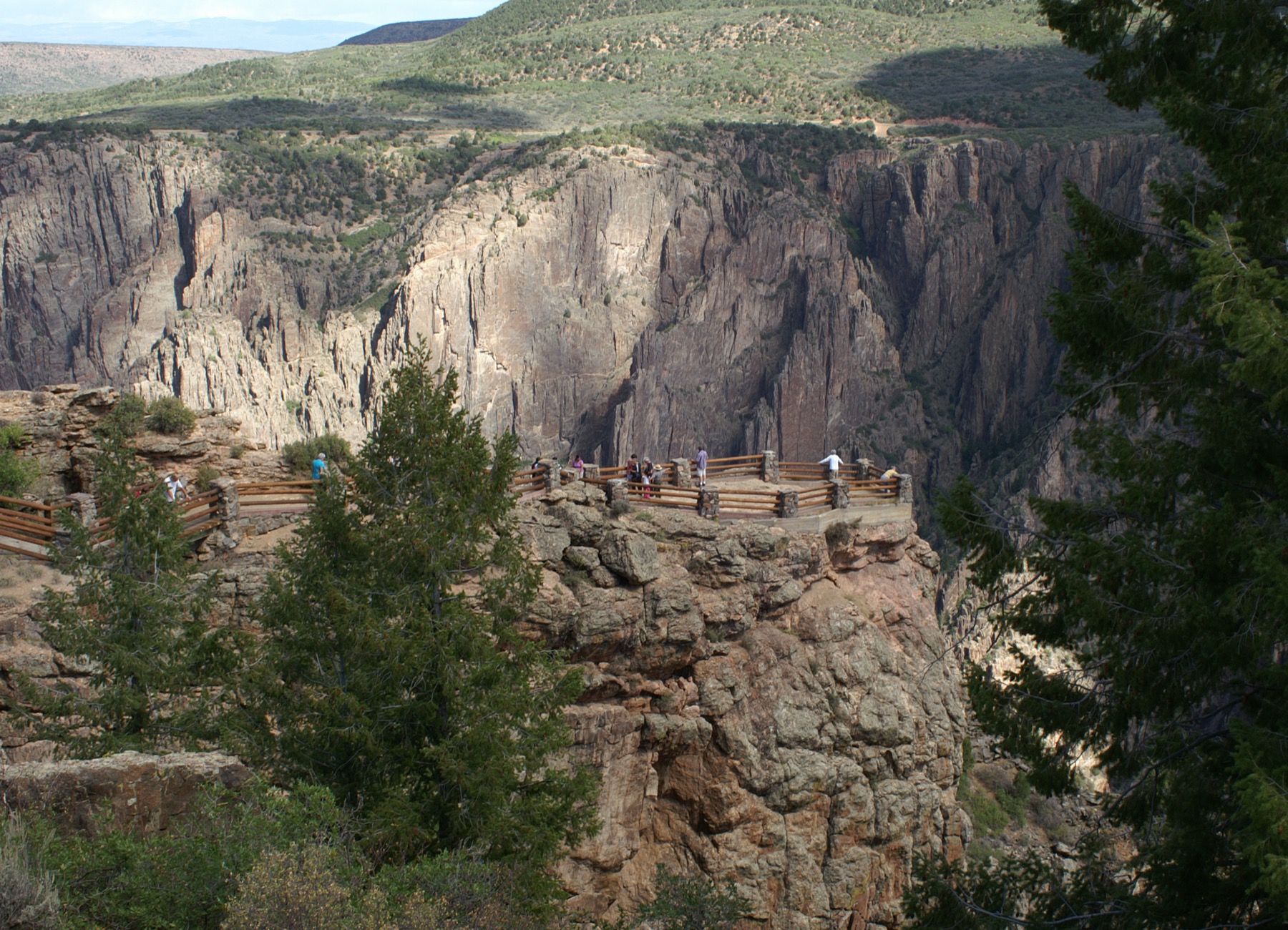 Visitors at Gunnison Point Overlook above the steep canyon walls
