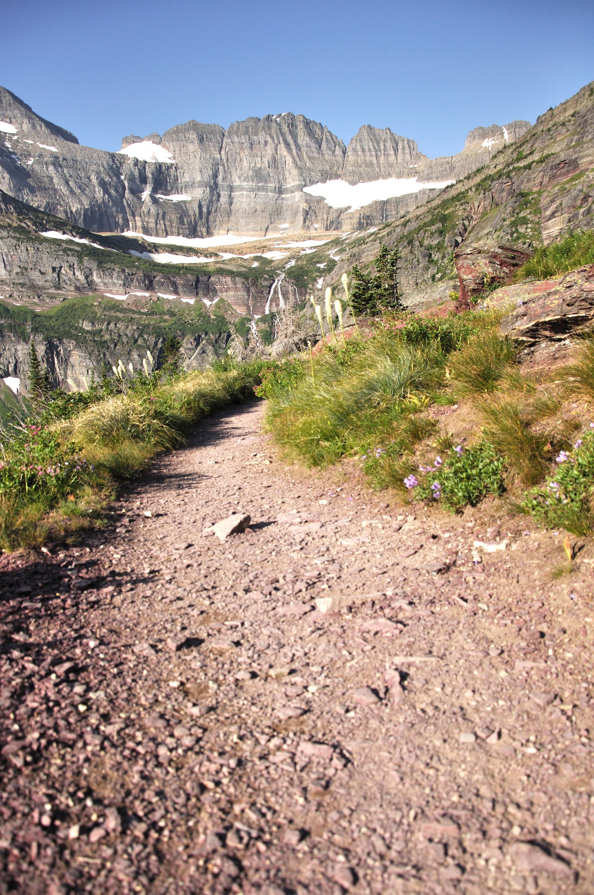 The Grinnell Glacier Trail crossing alpine slopes above turquoise water