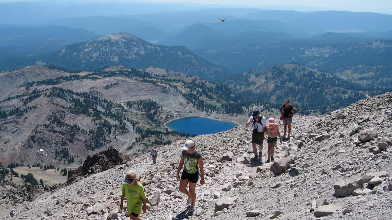 Hikers ascending the Lassen Peak Trail above alpine terrain