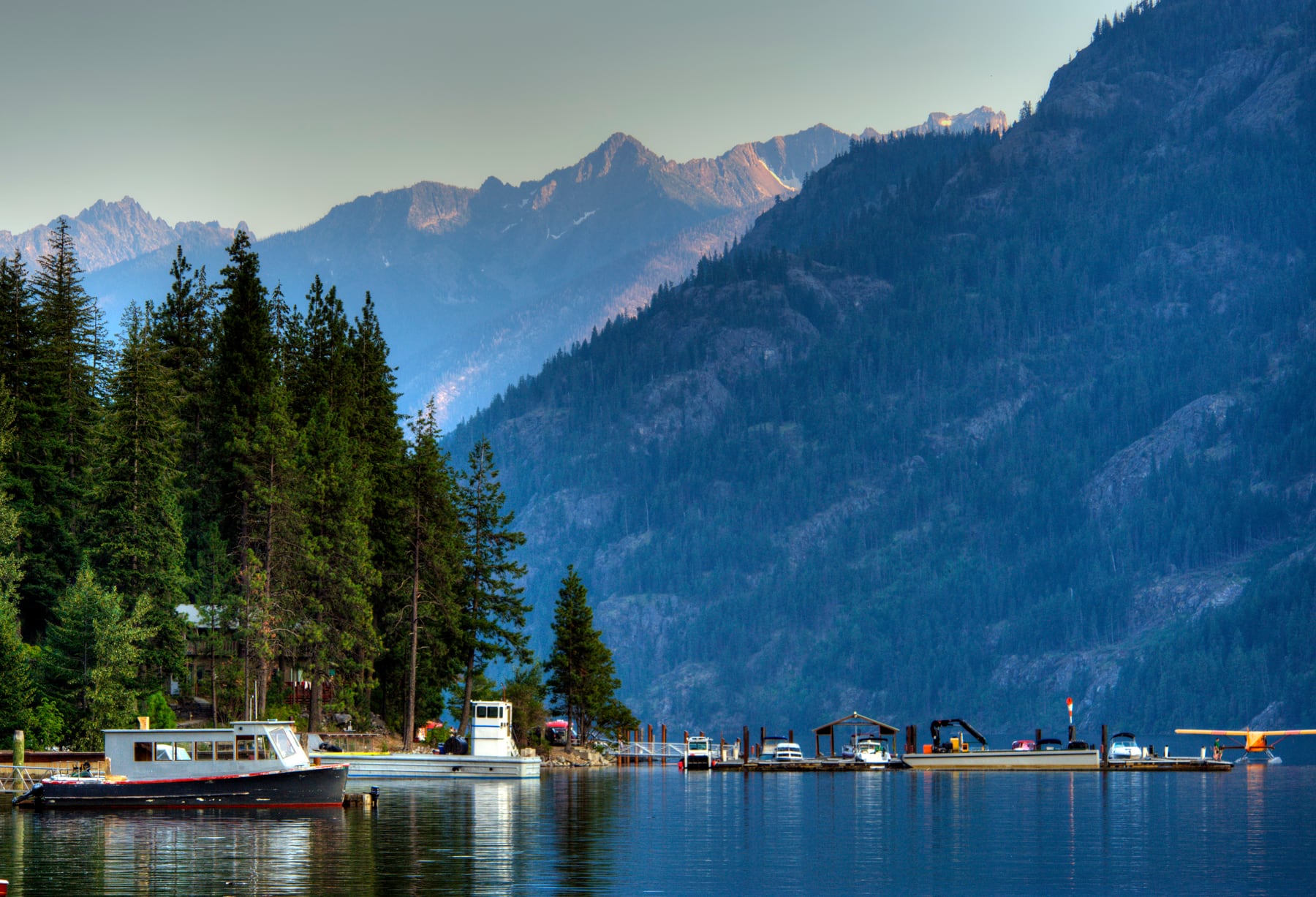 Boats on Lake Chelan near Stehekin with mountains around the water