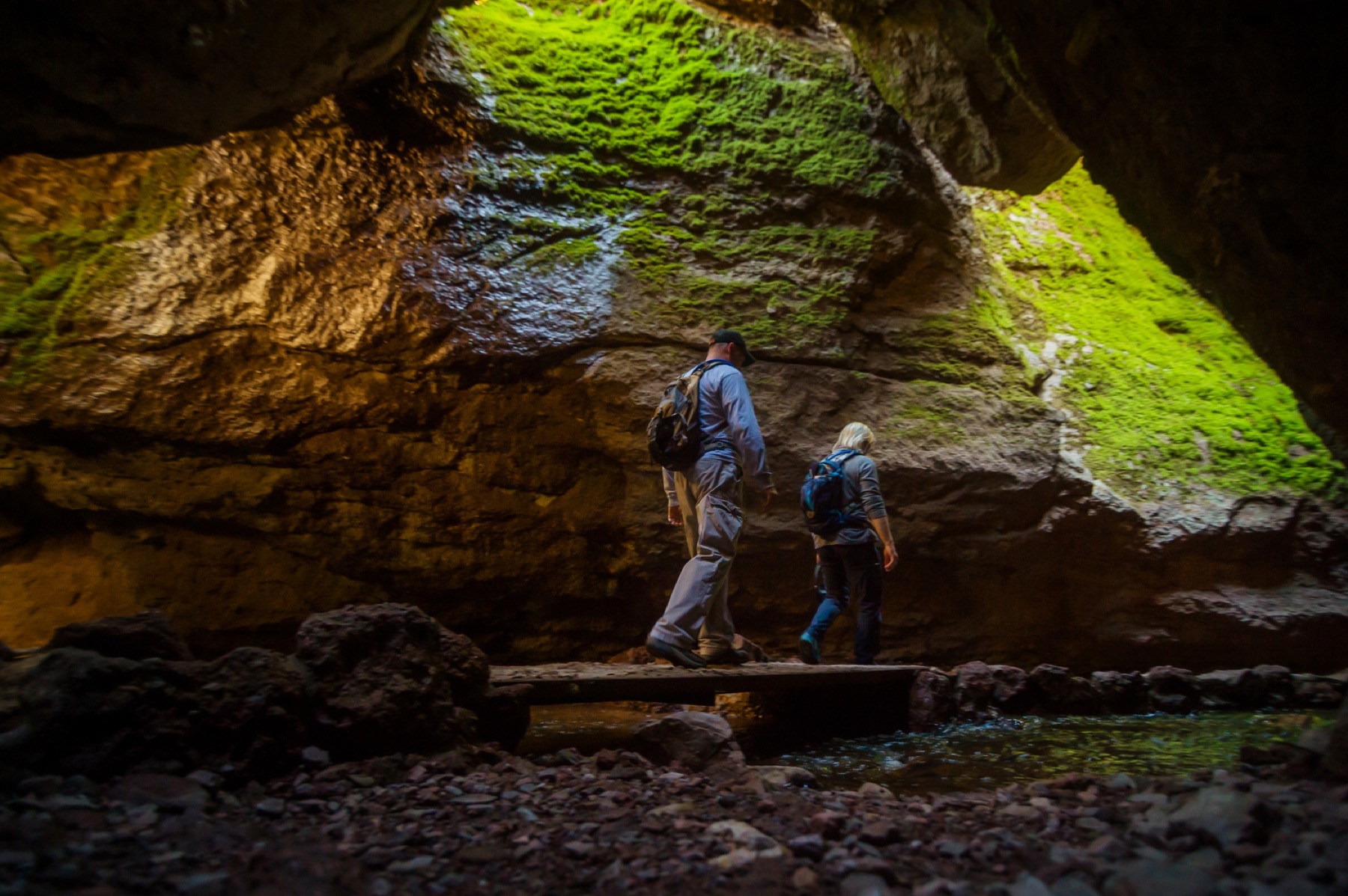 Visitors crossing a bridge into Bear Gulch Cave